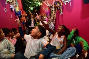 criancas apontando para obras de artesanato